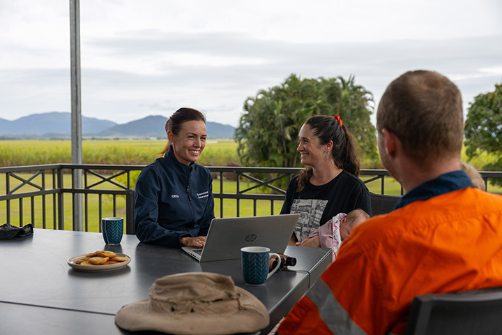 Regional Area Manager sits at a table with Sarah and Dylan Wedel talking. 