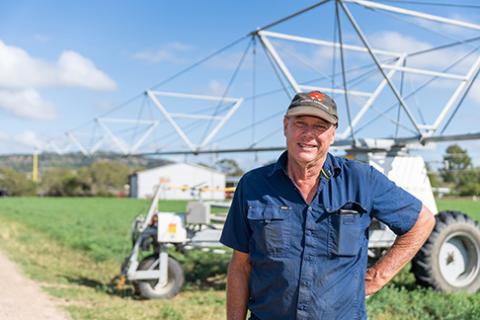 Man standing in front of irrigator